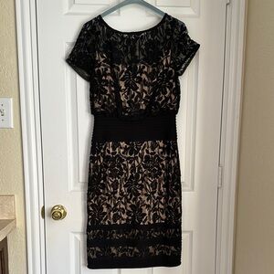 Black lace with beige liner cocktail dress. It has a blouson waist.